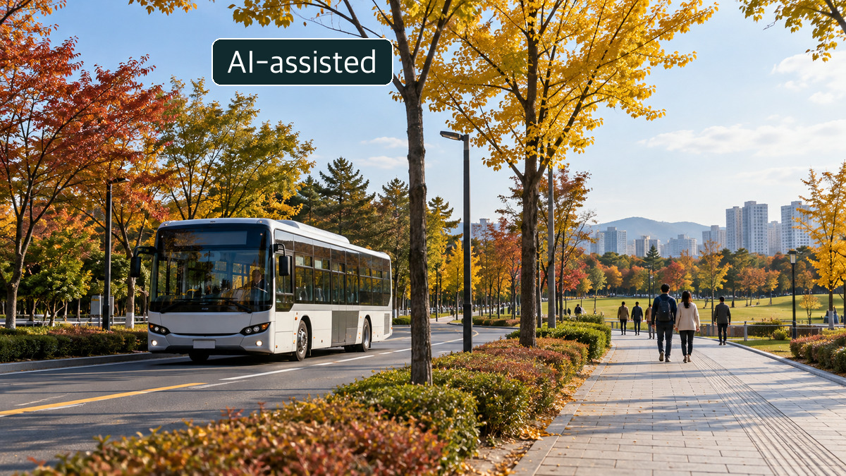 A white bus and pedestrians along an autumn city-park path.